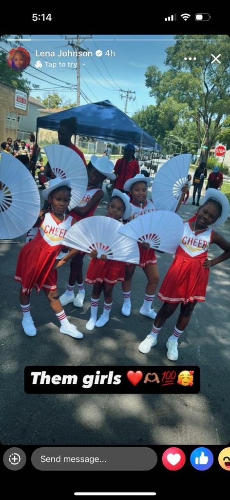 Reign Dancers in red and white uniforms at an outdoor event